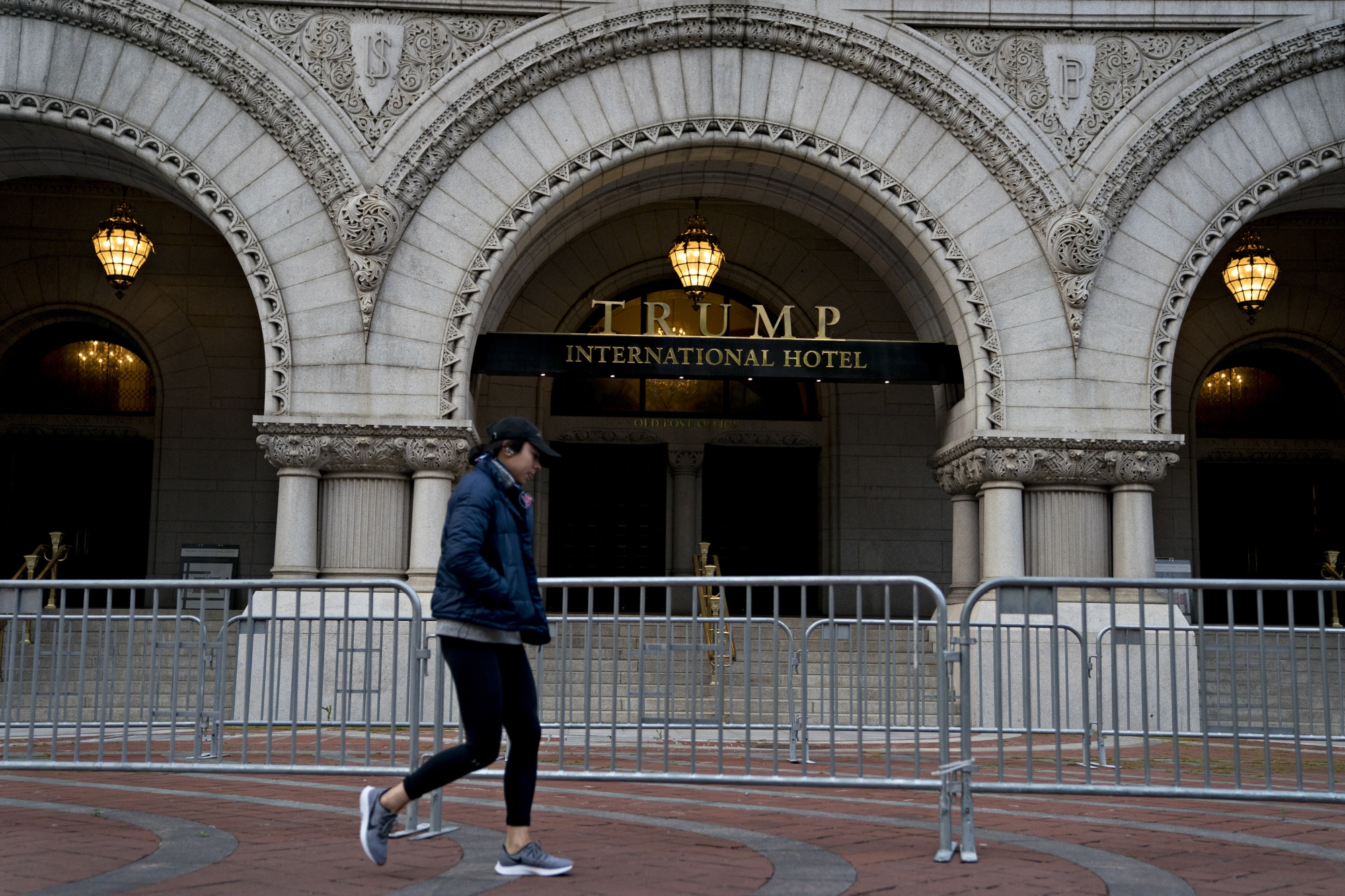 A pedestrian walks past the Trump International Hotel in Washington, D.C.