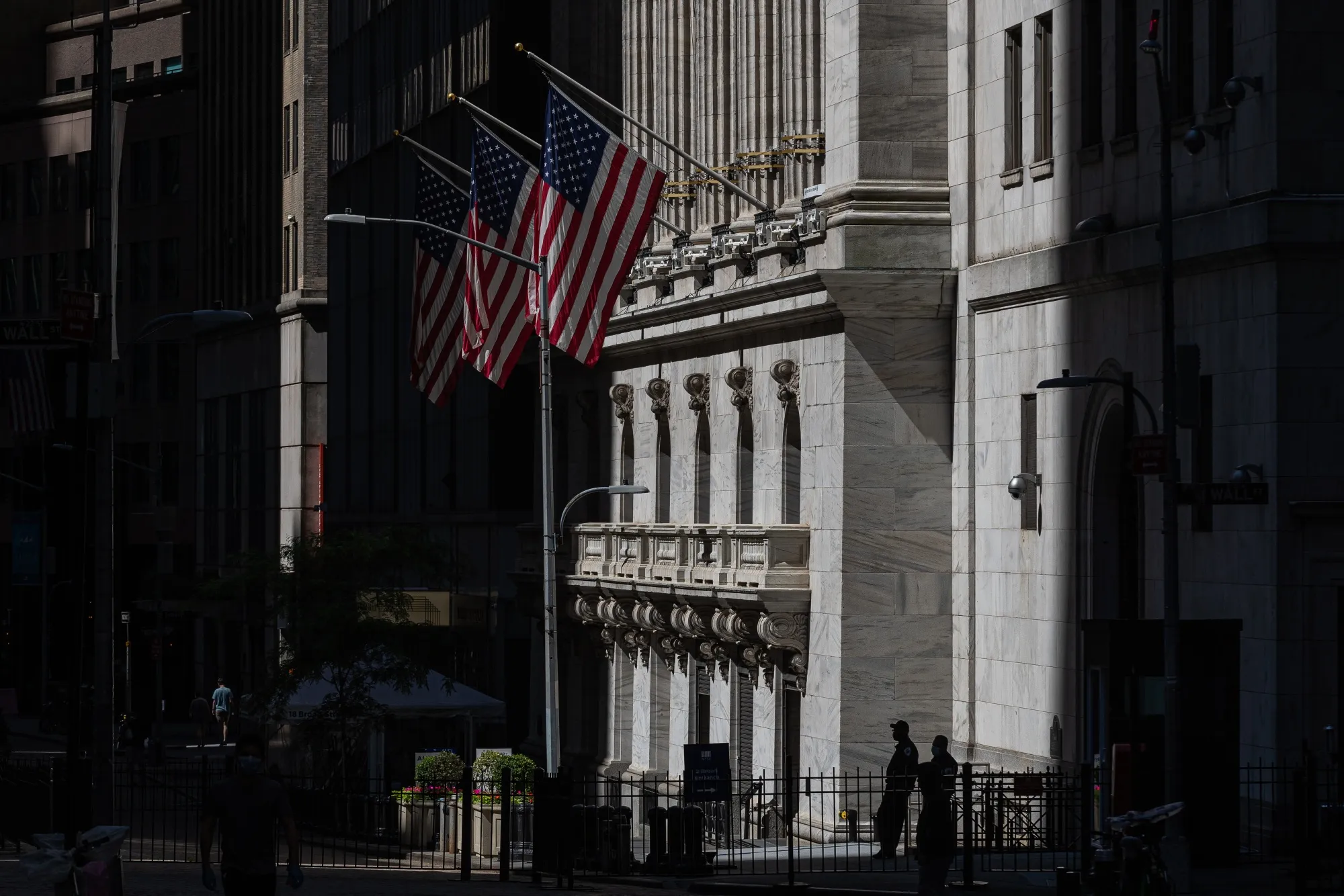 People stand outside&nbsp; the New York Stock Exchange on June 12.&nbsp;