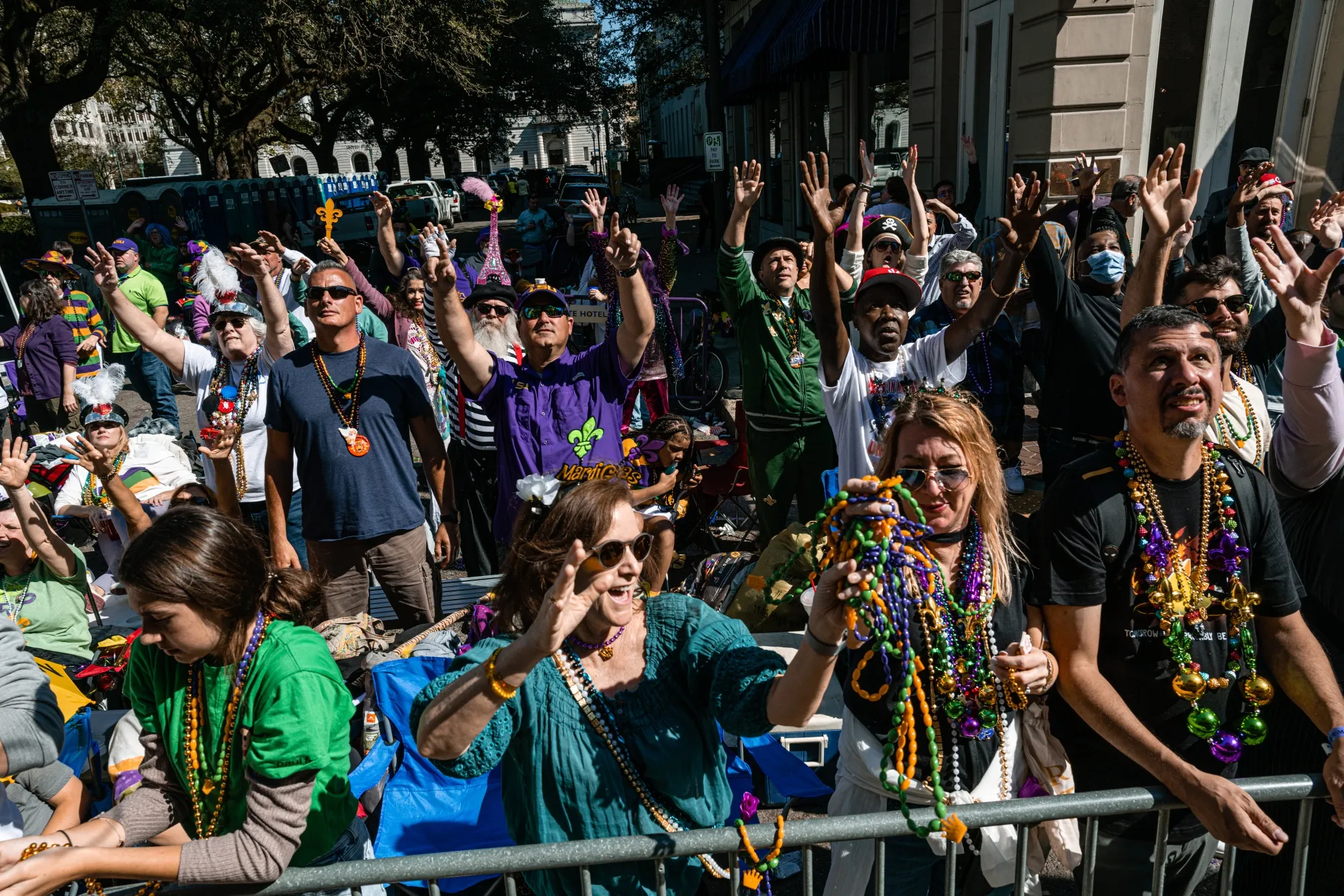 Attendees catch beads from floats at a parade during Fat Tuesday Mardi Gras celebrations in New Orleans, Louisiana, U.S., on Tuesday, Mar. 1, 2022.&nbsp;