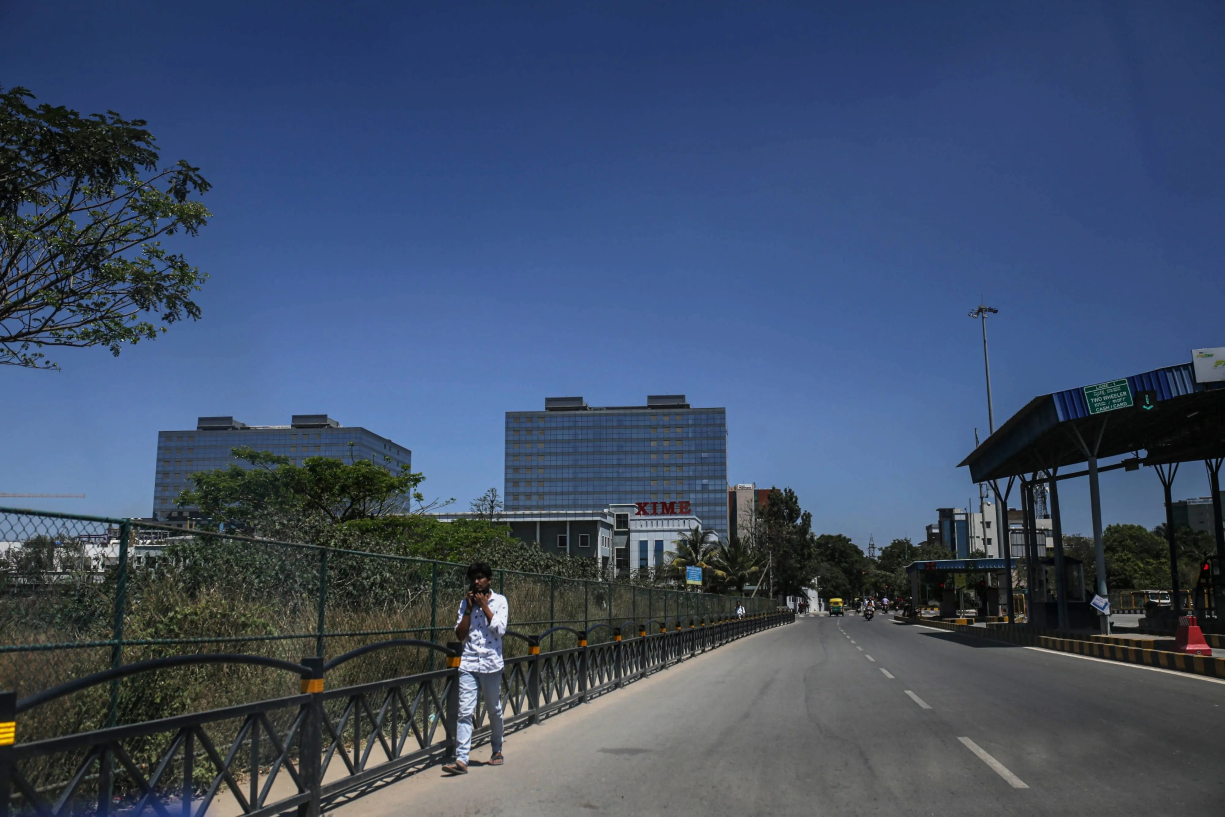A pedestrian walks along a road in the Electronic City area of Bengaluru, India, in 2021.&nbsp;