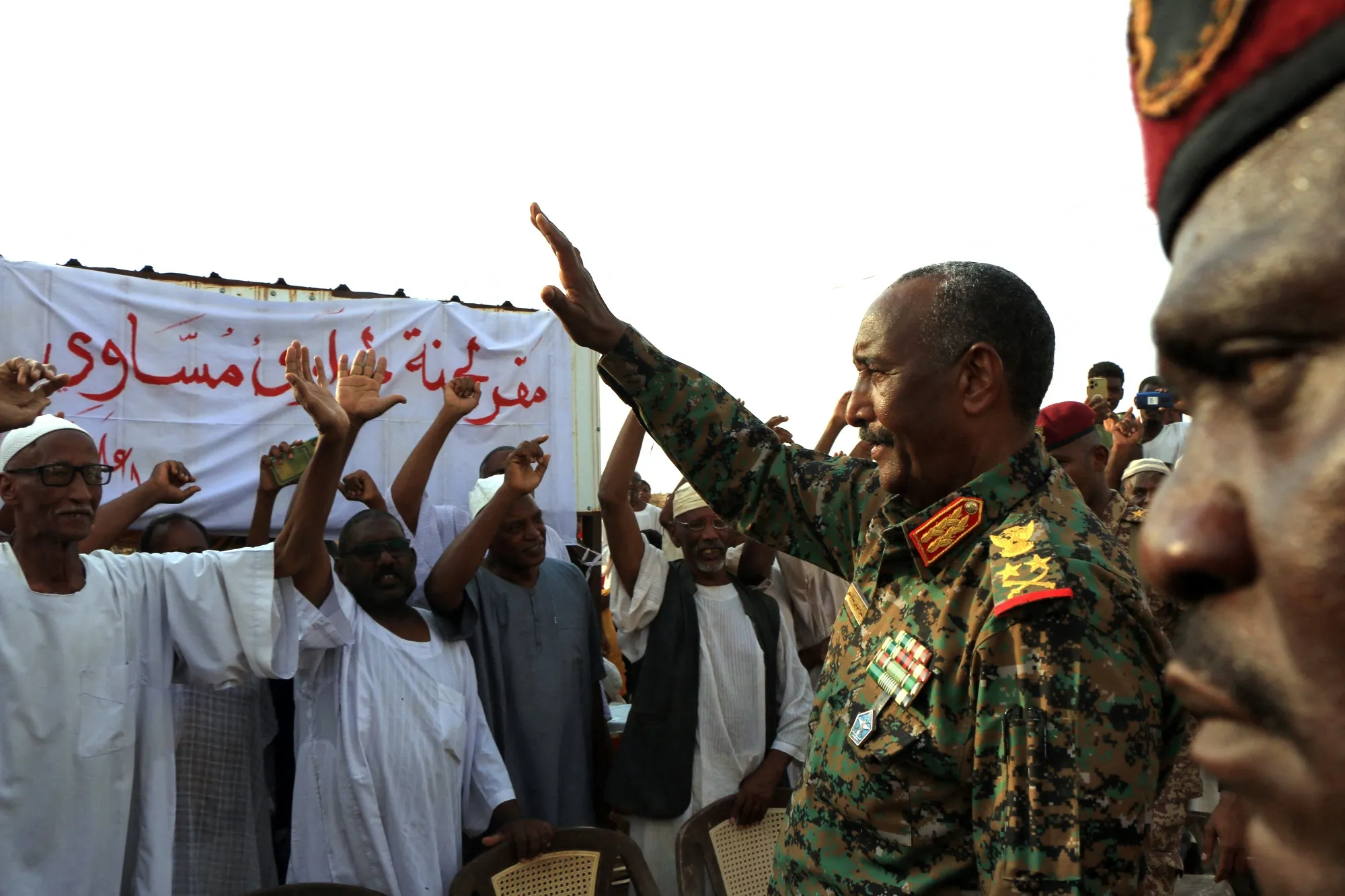 Abdel Fattah al-Burhan waves as he arrives in Meroe, Sudan.