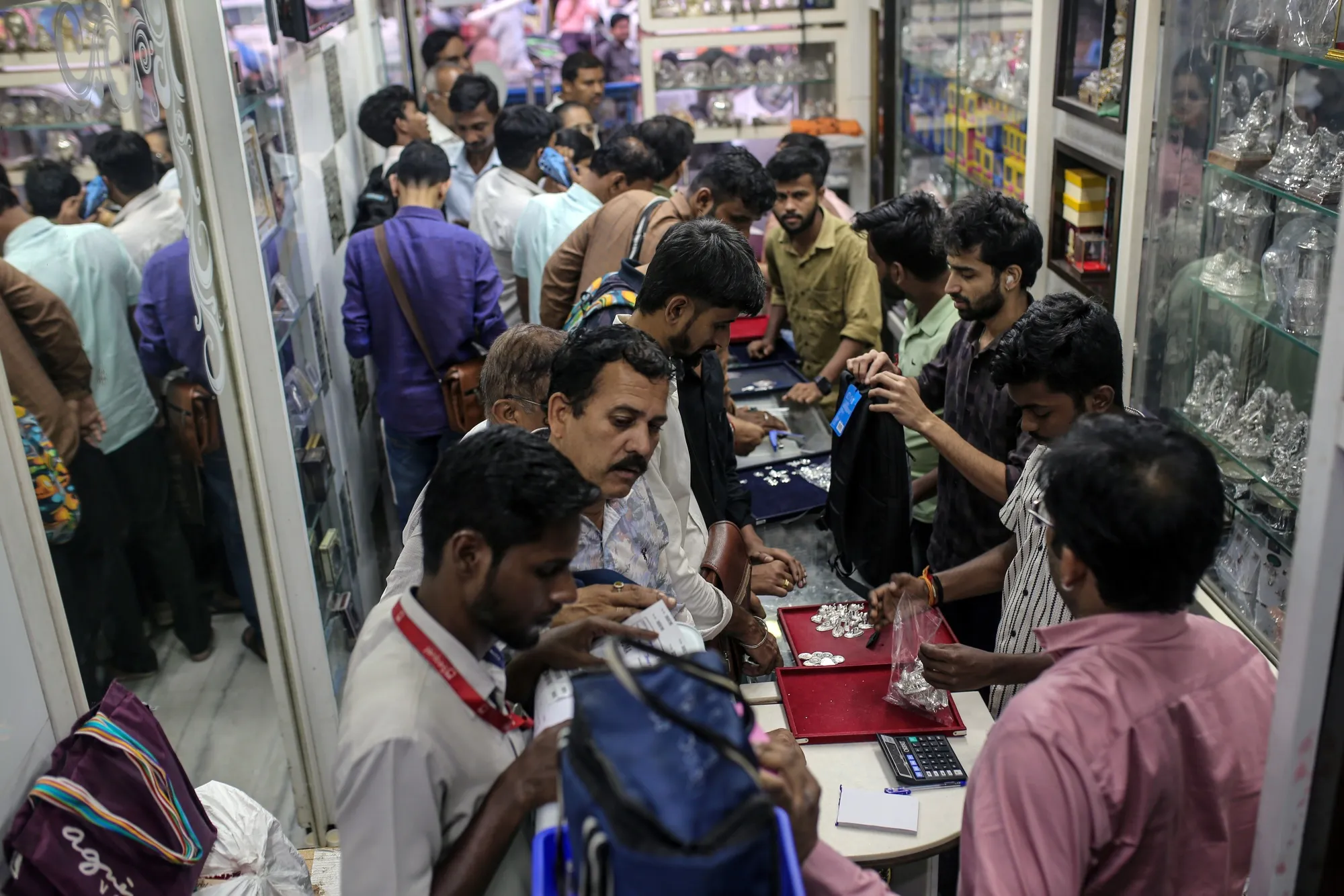 Customers purchase silver jewelry at a store in Mumbai on Oct. 17.