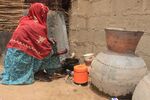 A woman cooks at Yawuri informal camp on the outskirts of Maiduguri, Nigeria, on March 29.
