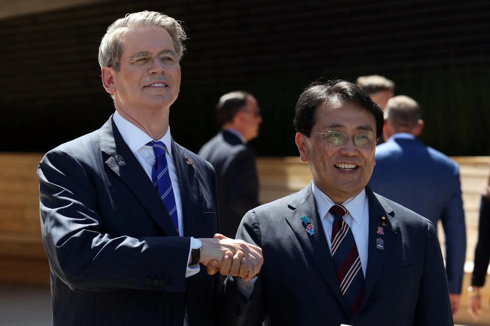 US Treasury Secretary Scott Bessent shakes hands with Japan's economic revitalisation minister Ryosei Akazawa at the Osaka Expo on July 19.