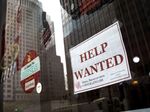 A 'help wanted' sign hangs on a window of a restaurant in Lower Manhattan.