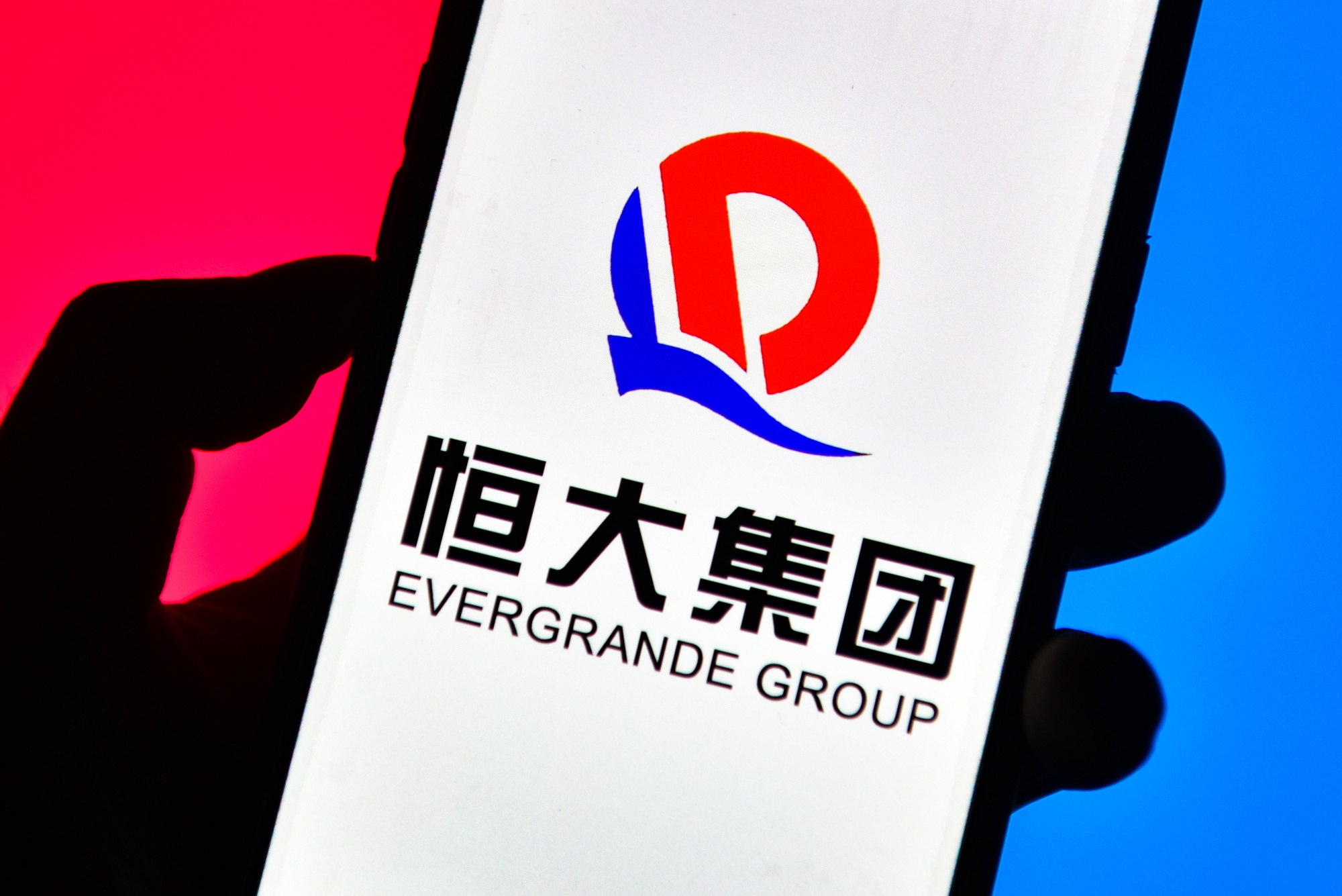 Evergrande Group logo is seen displayed on a smartphone. (Photo Illustration by Sheldon Cooper /SOPA Images/LightRocket via Getty Images)