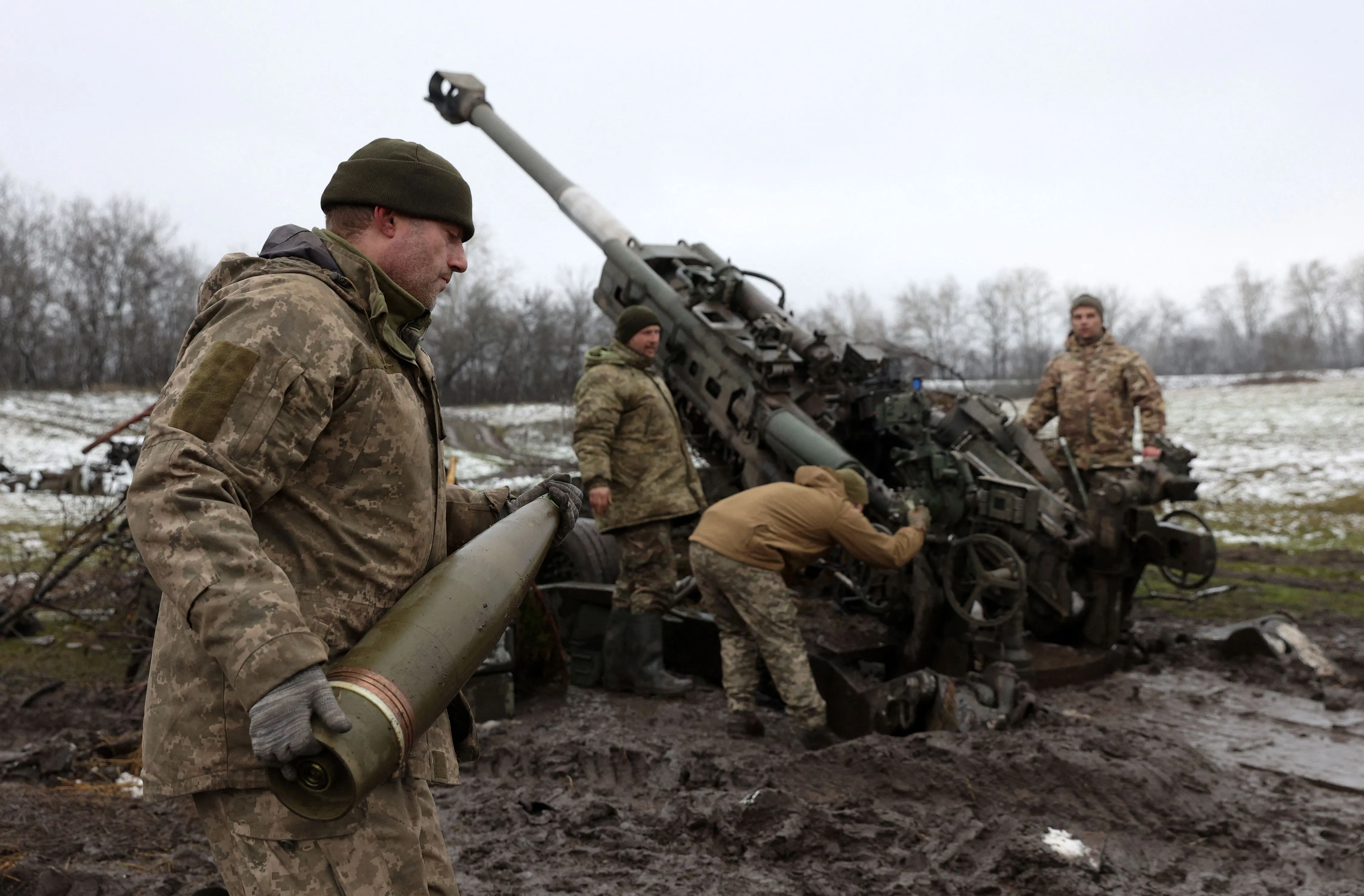 Ukrainian artillerymen fire a howitzer towards Russian positions in eastern Ukraine.