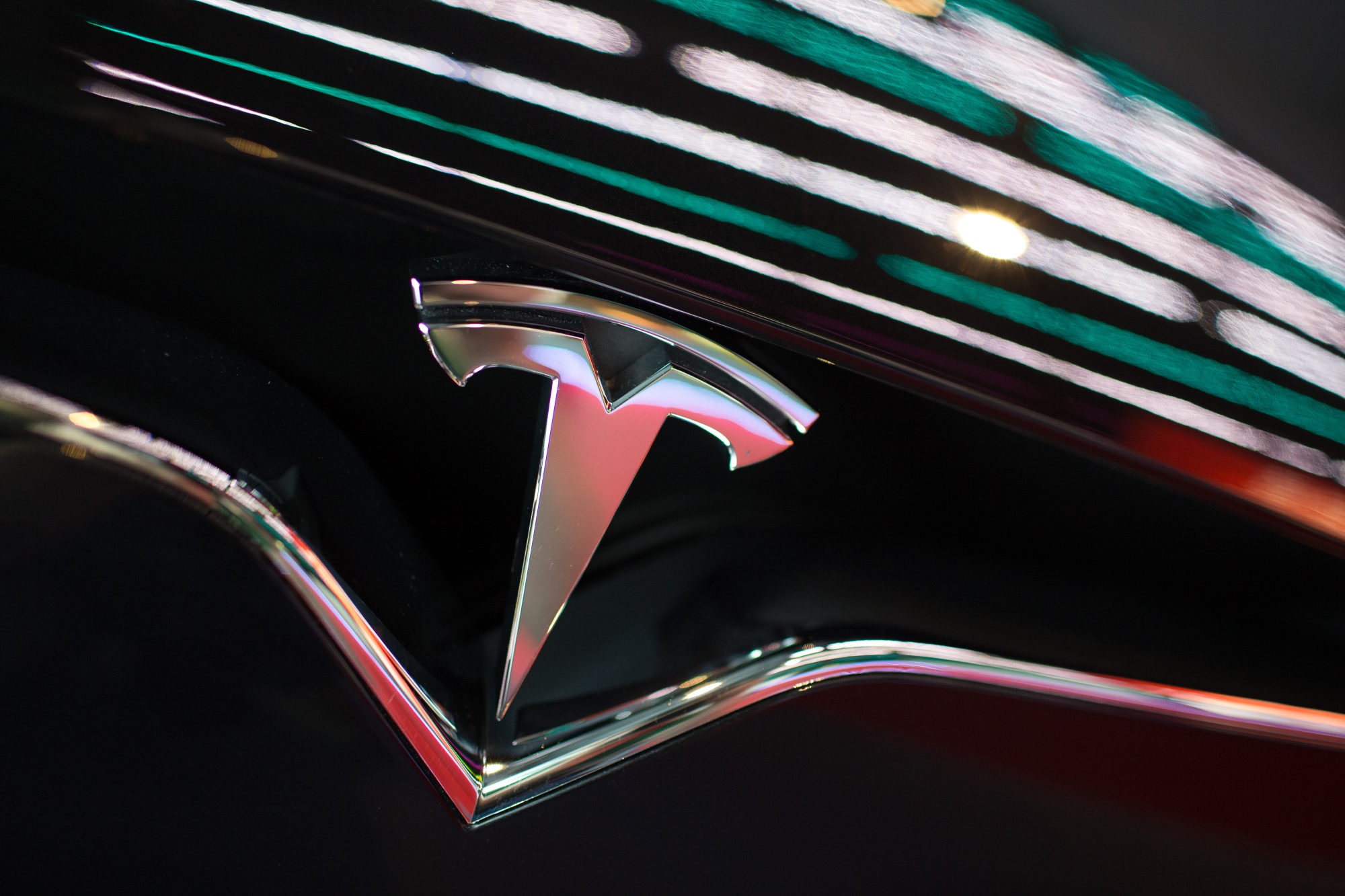 The Tesla Inc. logo is seen on the grille of a Model X electric vehicle.