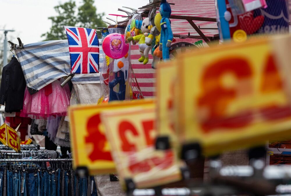 A British Union Jack flag above a clothing market stall in Barking, UK