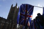 A British Union flag, also known as a Union Jack, flies beside a European Union (EU) flag.