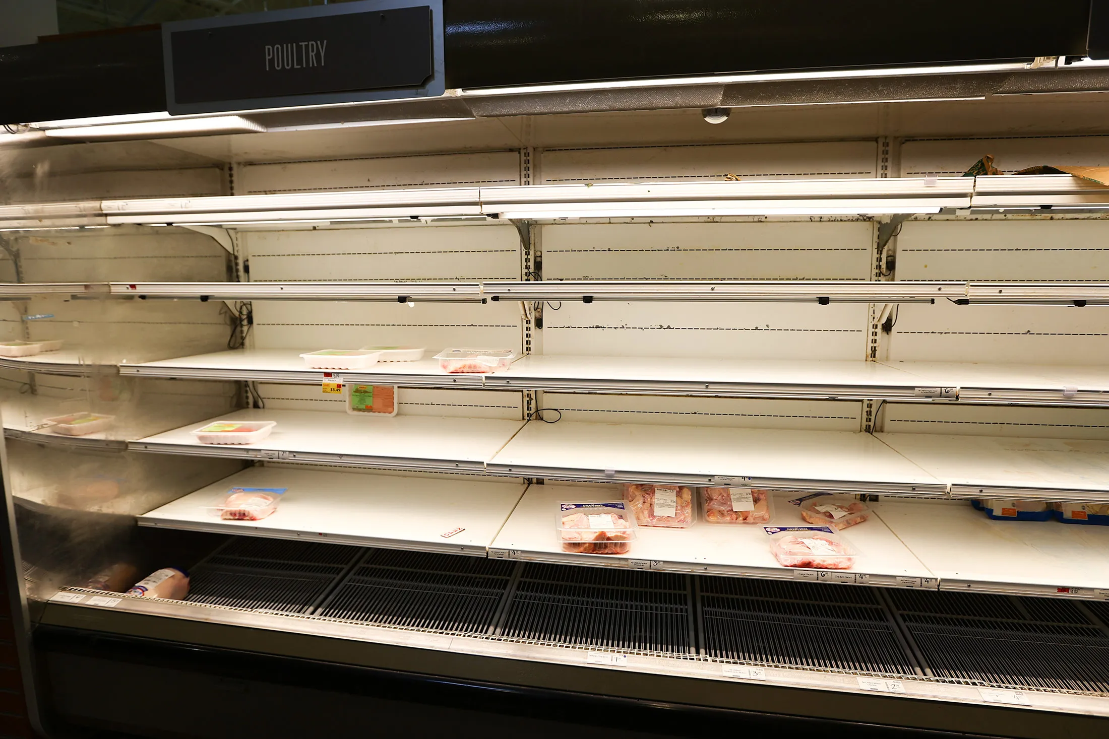 The chicken and poultry shelves sit nearly empty at Whole Foods Market in Vauxhall, New Jersey, on March 13.