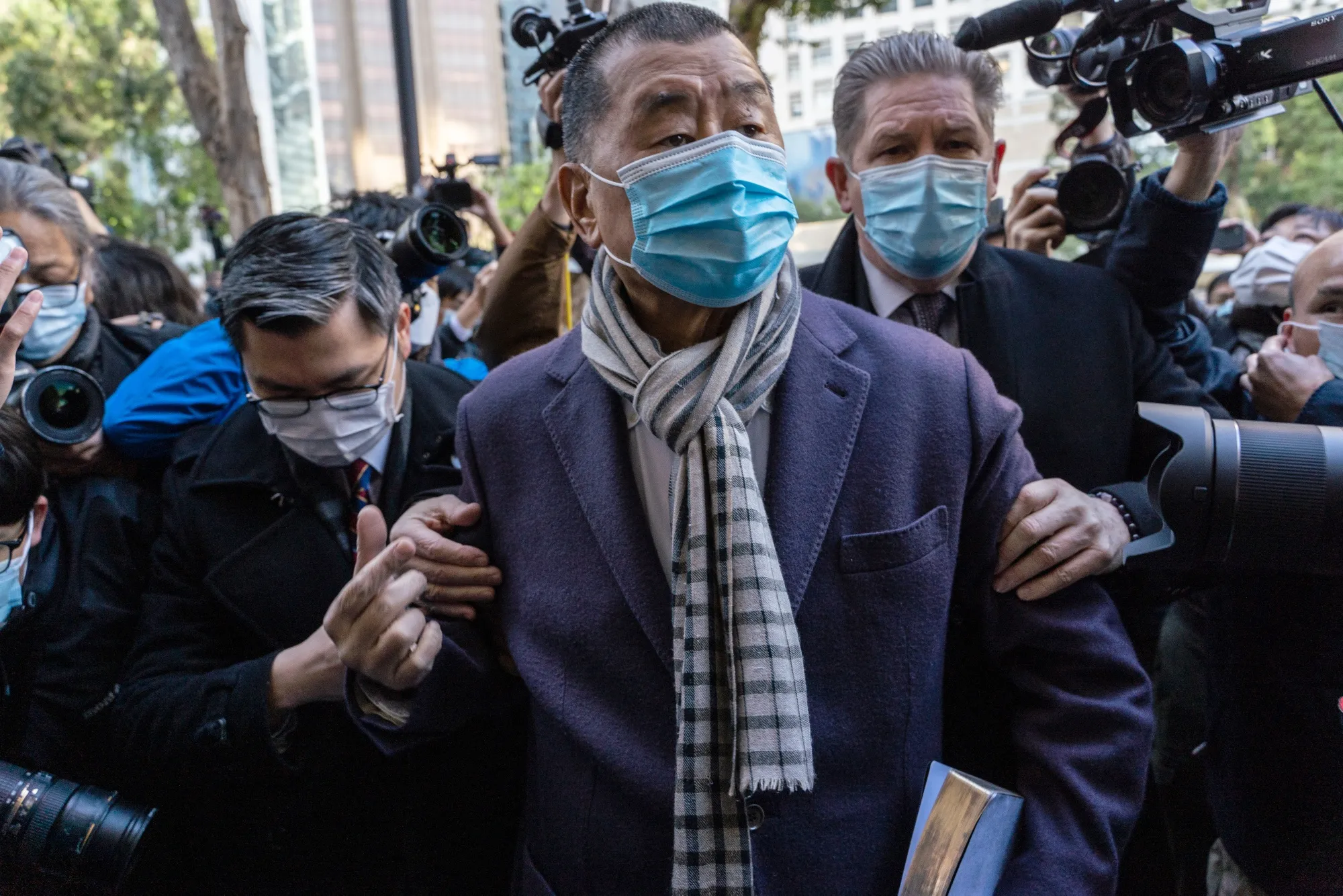 Jimmy Lai, center, arrives at the Court of Final Appeal for a hearing in Hong Kong, on Dec. 31, 2020.