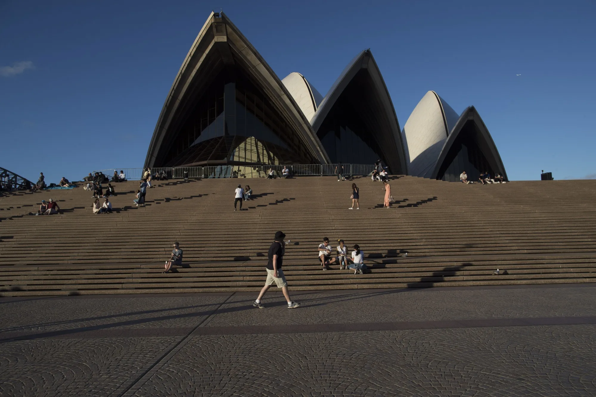 Visitors gather outside the Sydney Opera House in Sydney, Australia.