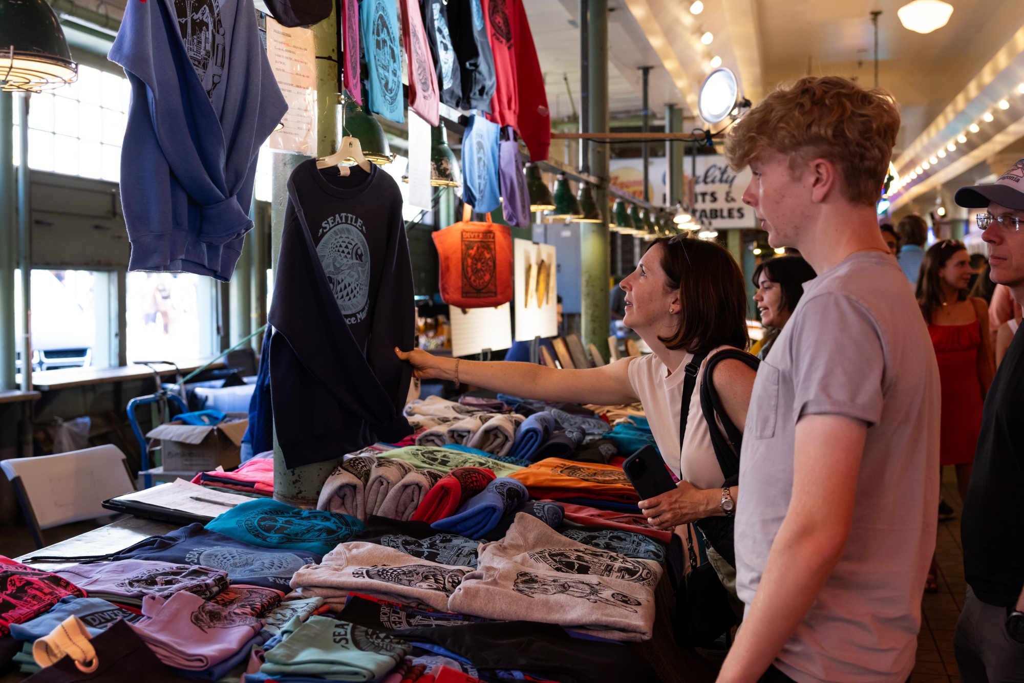 A customer looks at clothing for sale at the Pike Place Market in Seattle.