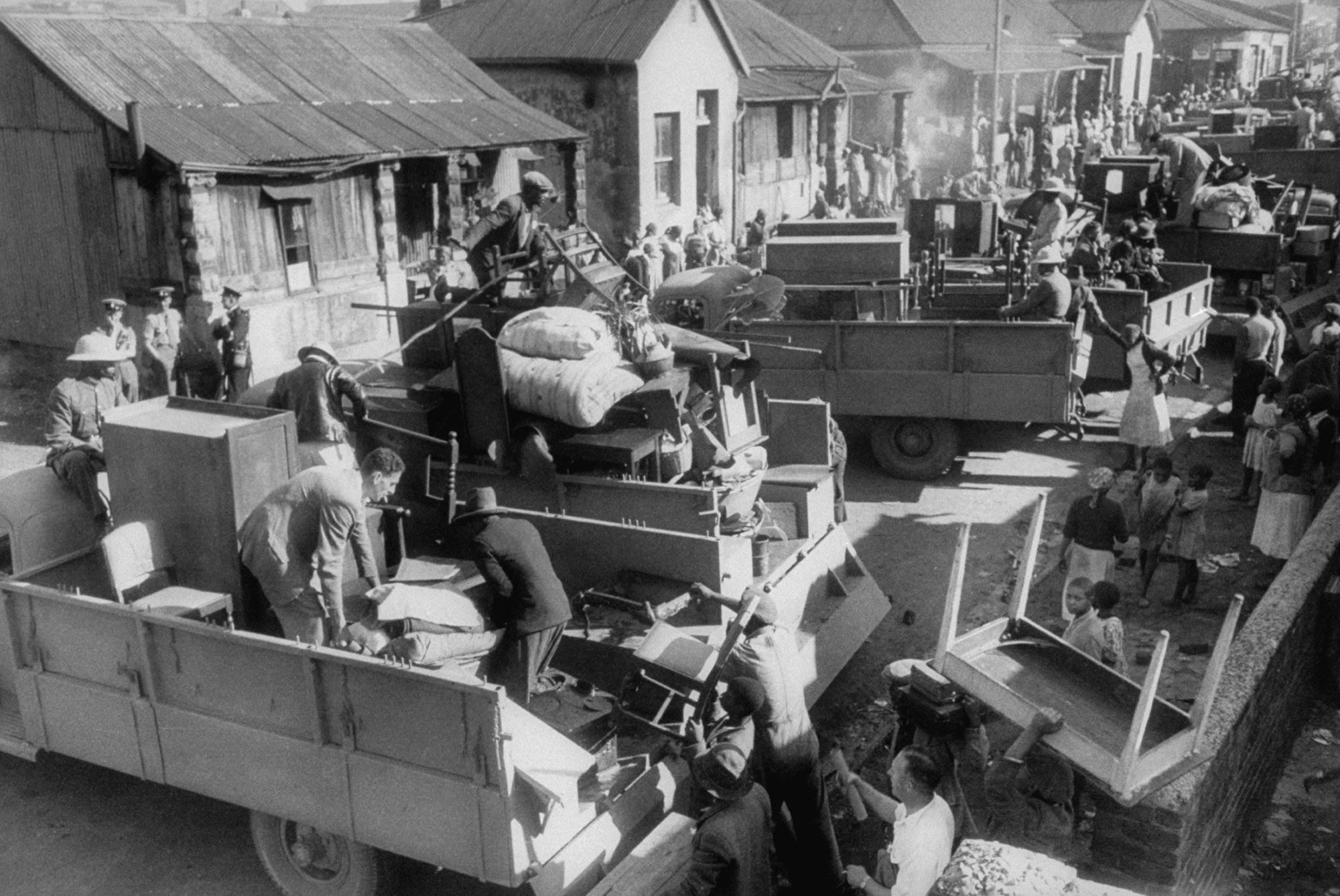 Families being removed from their homes in Johannesburg in 1955, that year residents were also forced from the Black cultural hub of Sophiatown to create a Whites-only suburb.