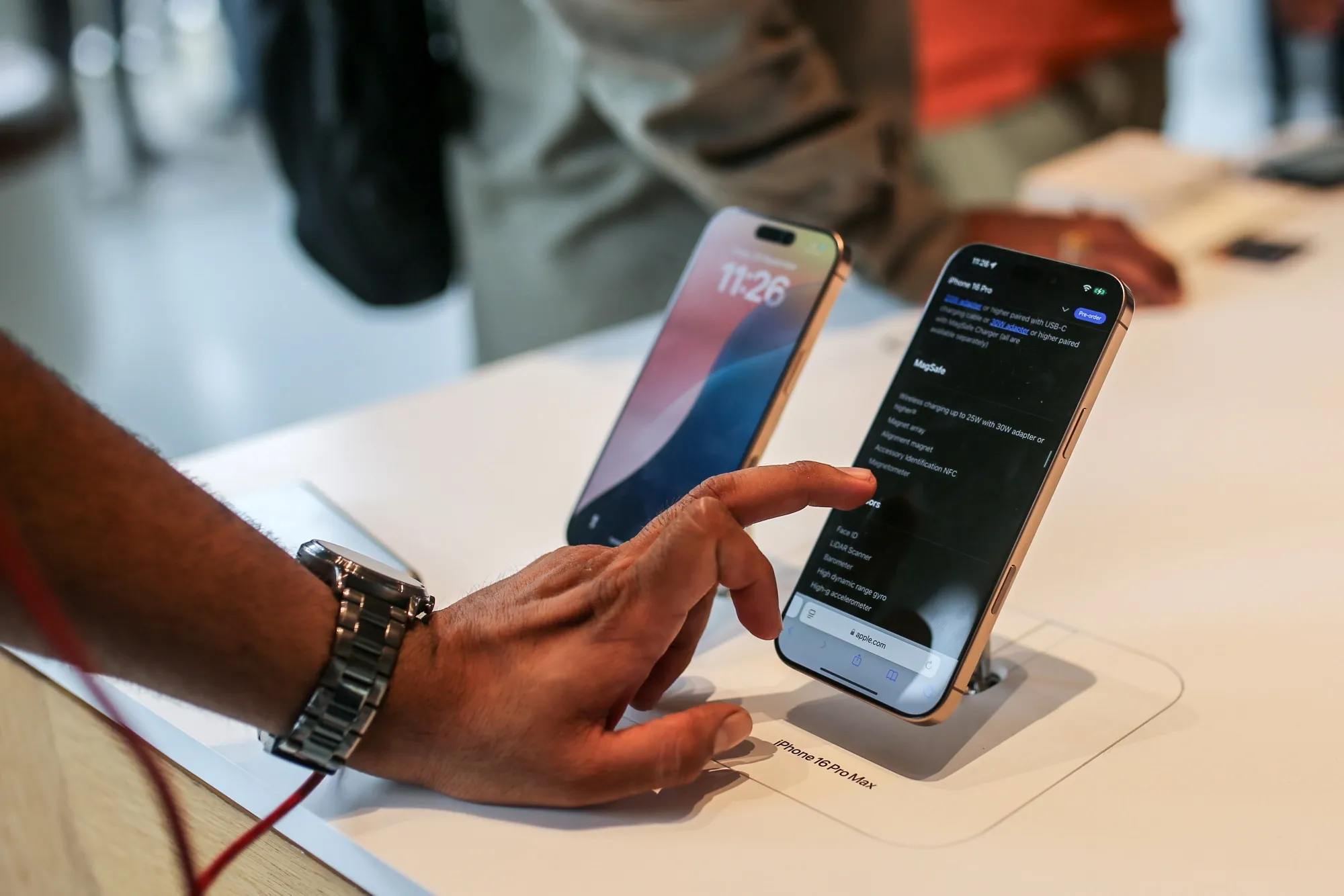 A customer looks at an Apple iPhone 16 Pro Max smartphone.