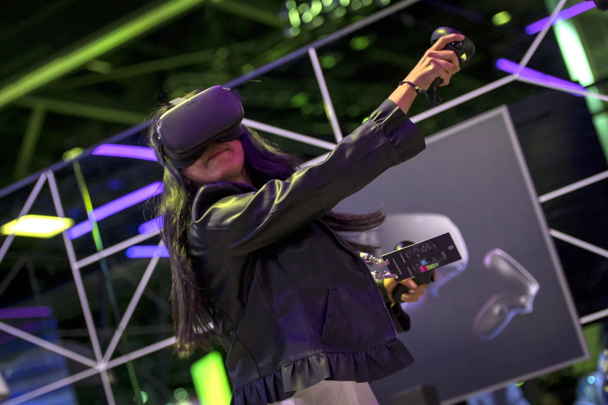 The person uses the Oculus VR Inc. Quest virtual reality&nbsp;headset and controllers.