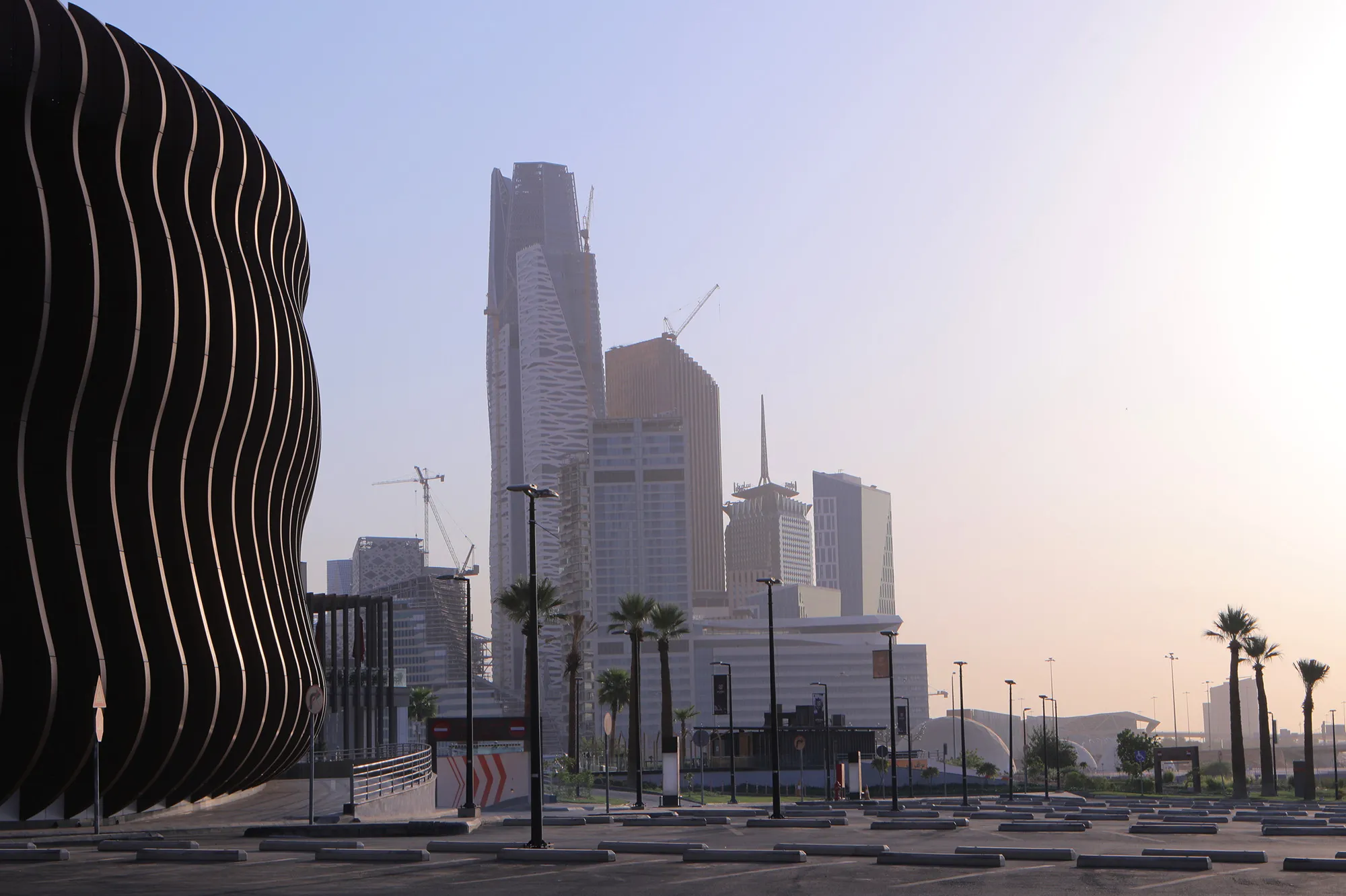 Skyscrapers stand in the King Abdullah Financial District beyond an empty parking lot in Riyadh, on&nbsp;July 28.