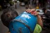 A man carries a bottle of LPG in Manila, Philippines.