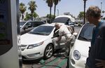Electric car drivers at a charging station in Los Angeles, California.