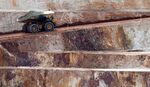 A dump truck drives along a haul road in an open pit mine west of Kalgoorlie, Australia.
