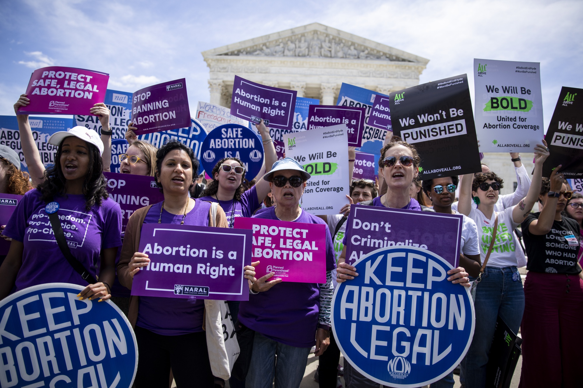 Pro-choice activists holds signs during a rally in front of the U.S. Supreme Court.