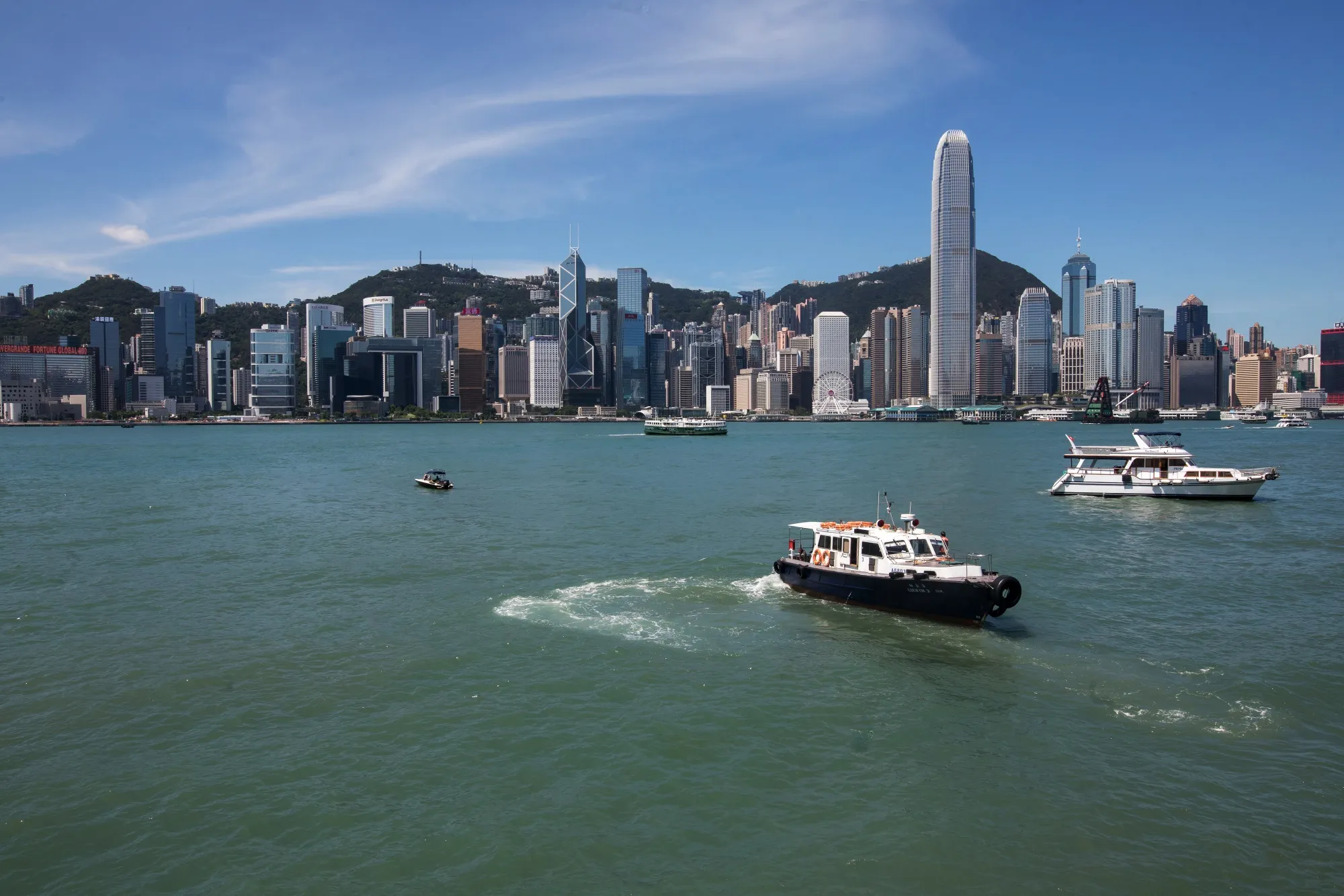 Boats sail across Victoria Harbour in Hong Kong.