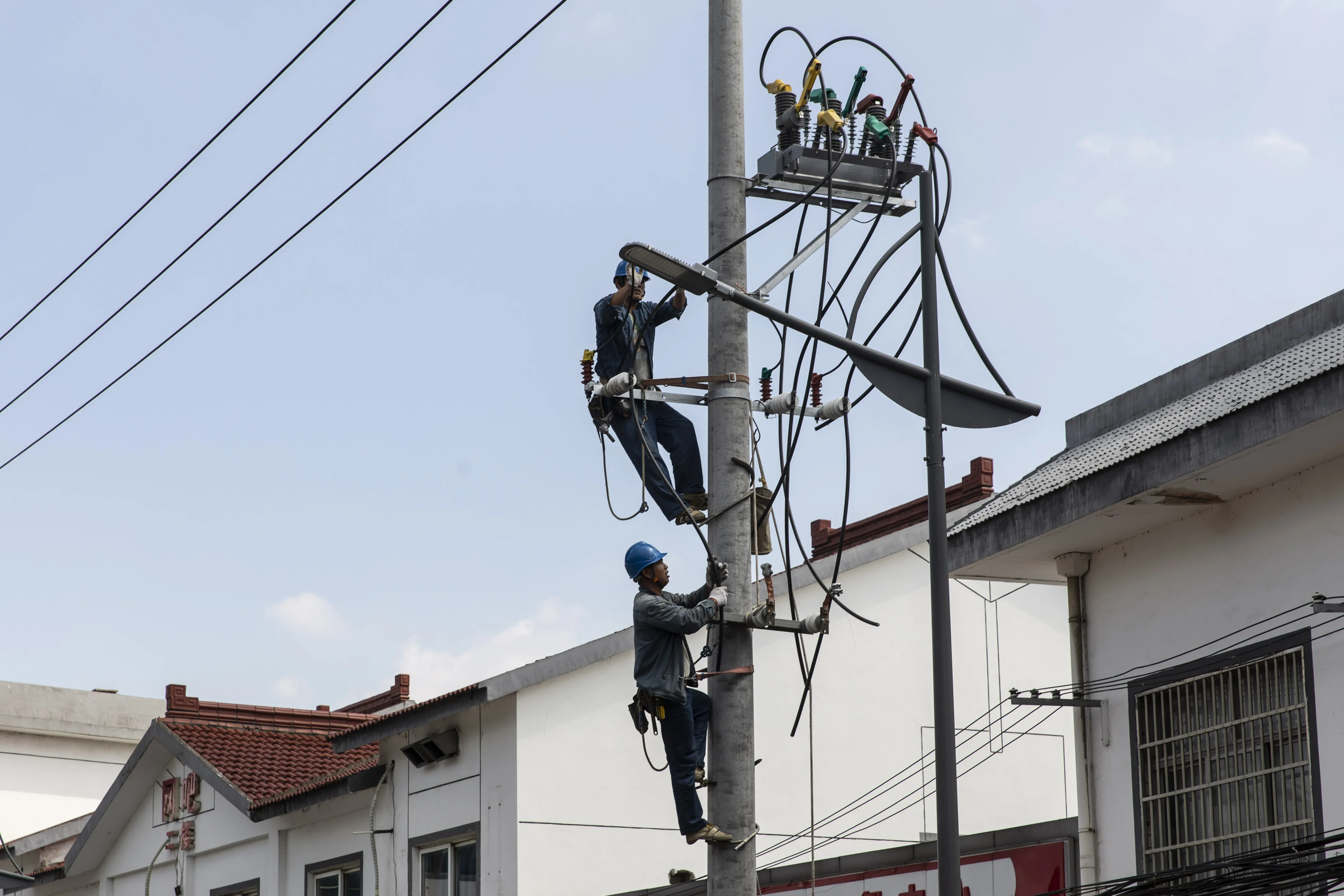 Technicians install new power lines in Wangting, Jiangsu province, China.