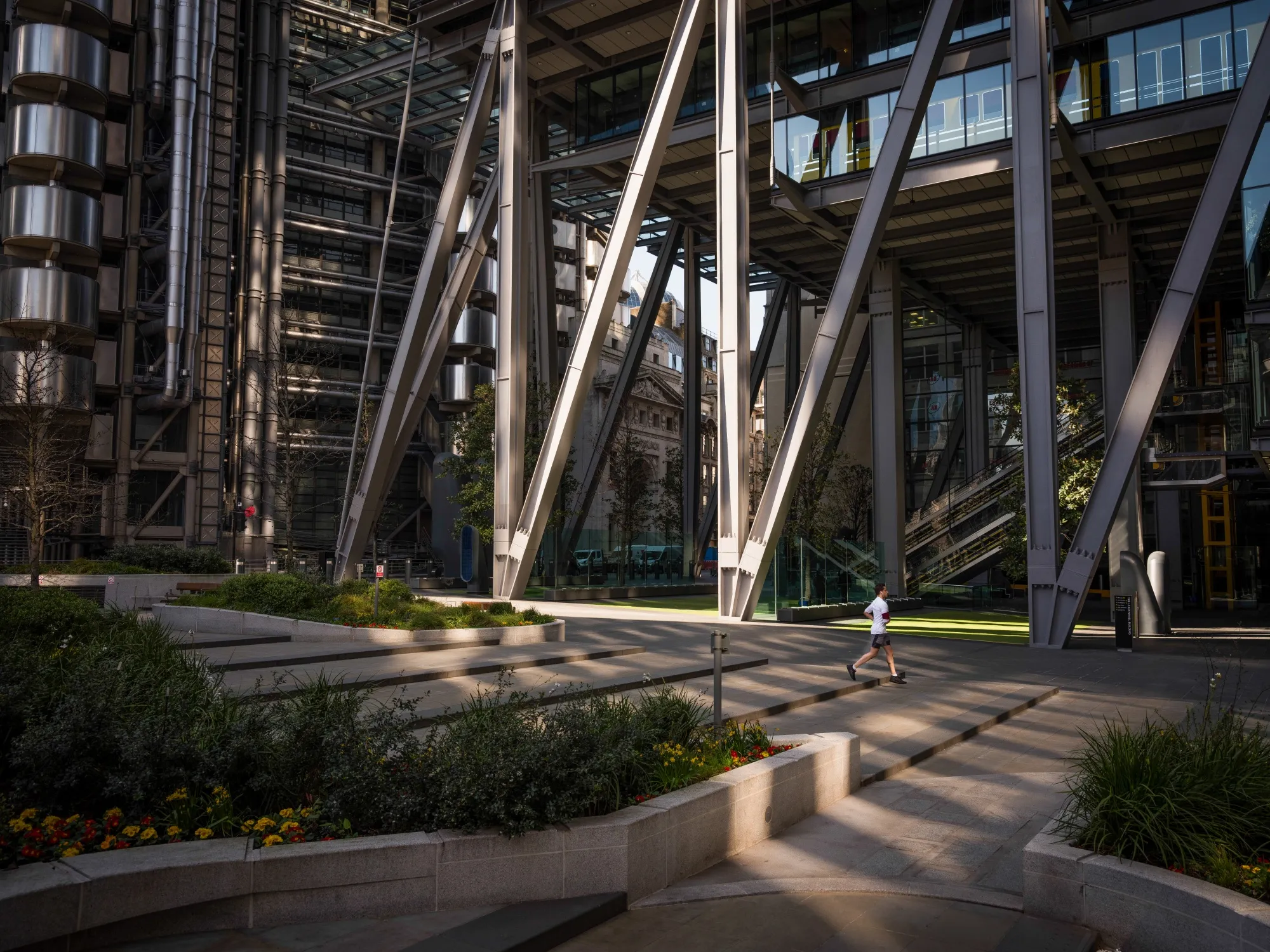 A jogger runs past office blocks in the City of London.