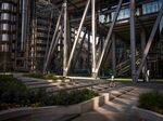 A jogger runs past office blocks in the City of London.
