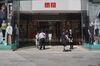 Employees speak to customers about a temporary closure due the coronavirus at a Uniqlo store, operated by Fast Retailing Co., in Ginza shopping district in Tokyo, Japan, on April 8, 2020. Prime Minister Shinzo Abe warned Japan could be facing as many as 80,000 confirmed coronavirus cases in a month if no action is taken as he declared a state of emergency in Tokyo and its surrounding regions.