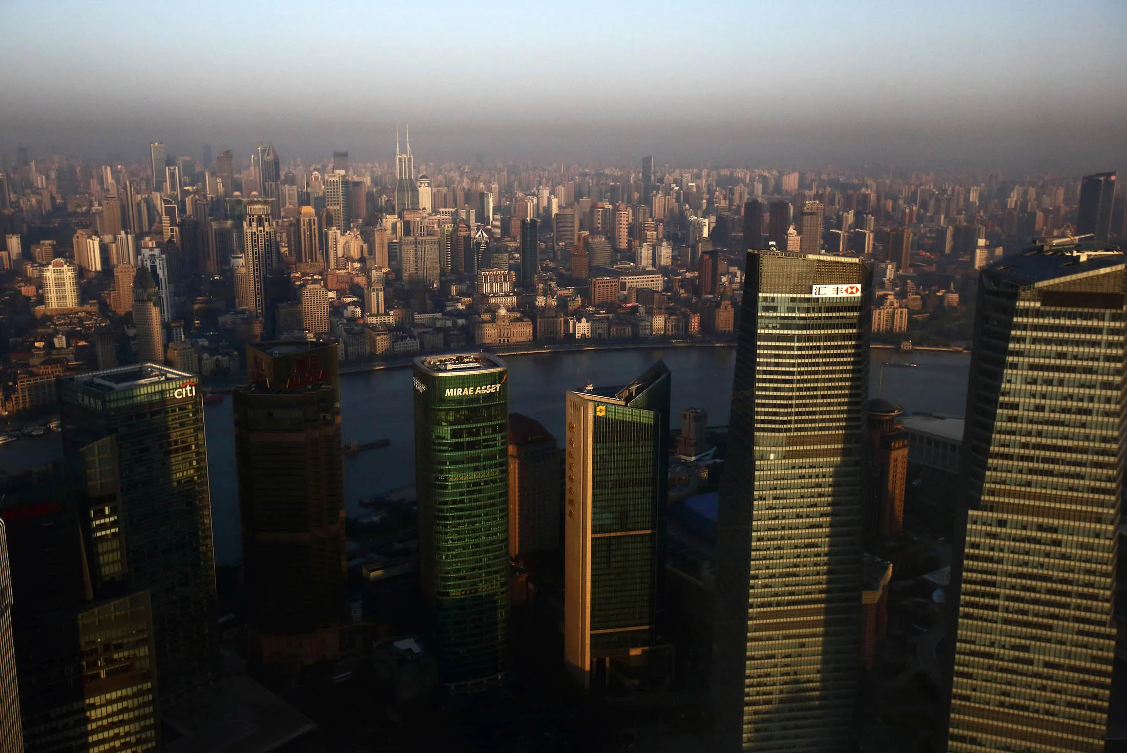 Commercial and residential buildings stand in Shanghai, China, on Tuesday, April 21, 2015. China's gross domestic product expanded 7 percent in the three months through March from a year earlier.
