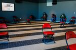 Residents wait to receive the Covid-19 vaccine during an event hosted by the Miami Heat at the FTX Arena in Miami, Florida, U.S., on Thursday, Aug. 5, 2021.