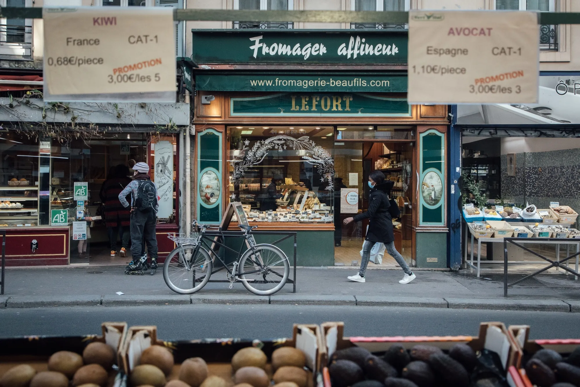 A pedestrian passes storefronts&nbsp;in Paris, France.