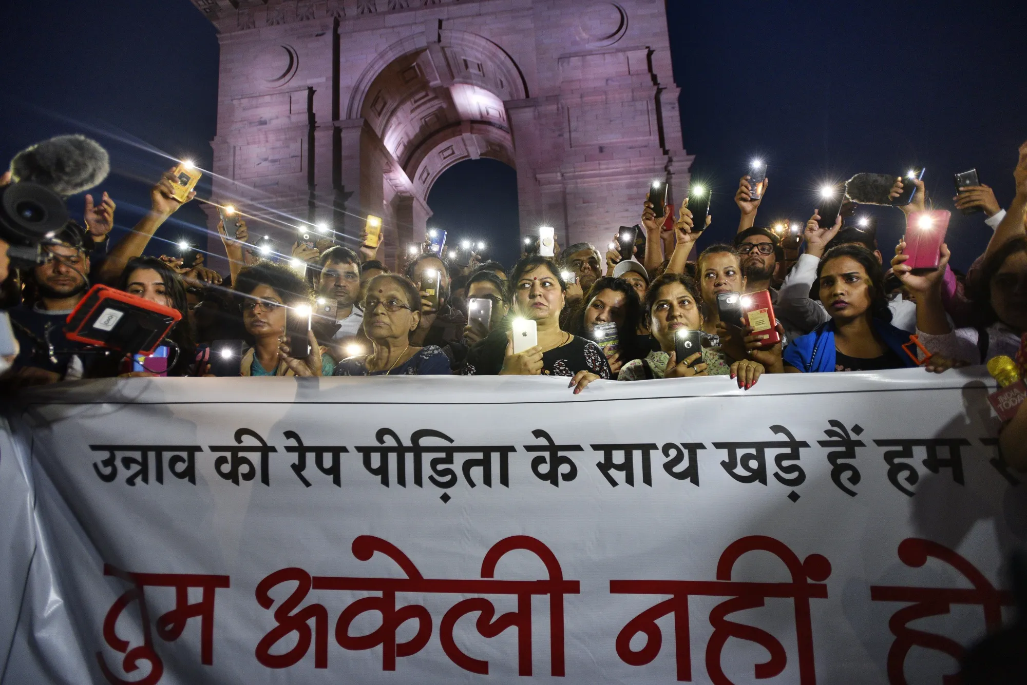 People gather for a silent protest in support of the Unnao rape case victim at India Gate in New Delhi, on July 29, 2019.