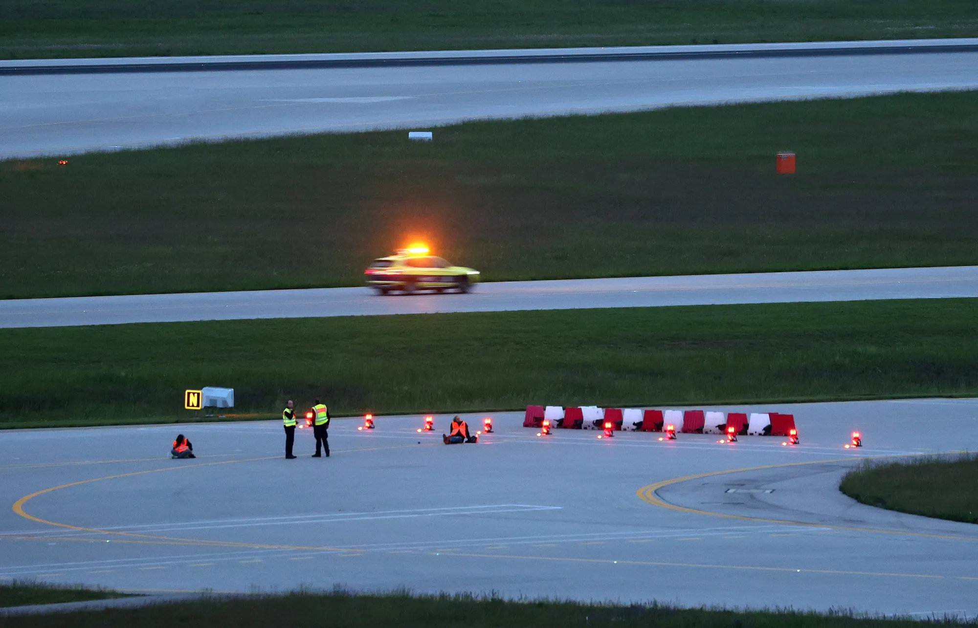 Climate activists on the&nbsp;runway at Munich Airport early on May 18.