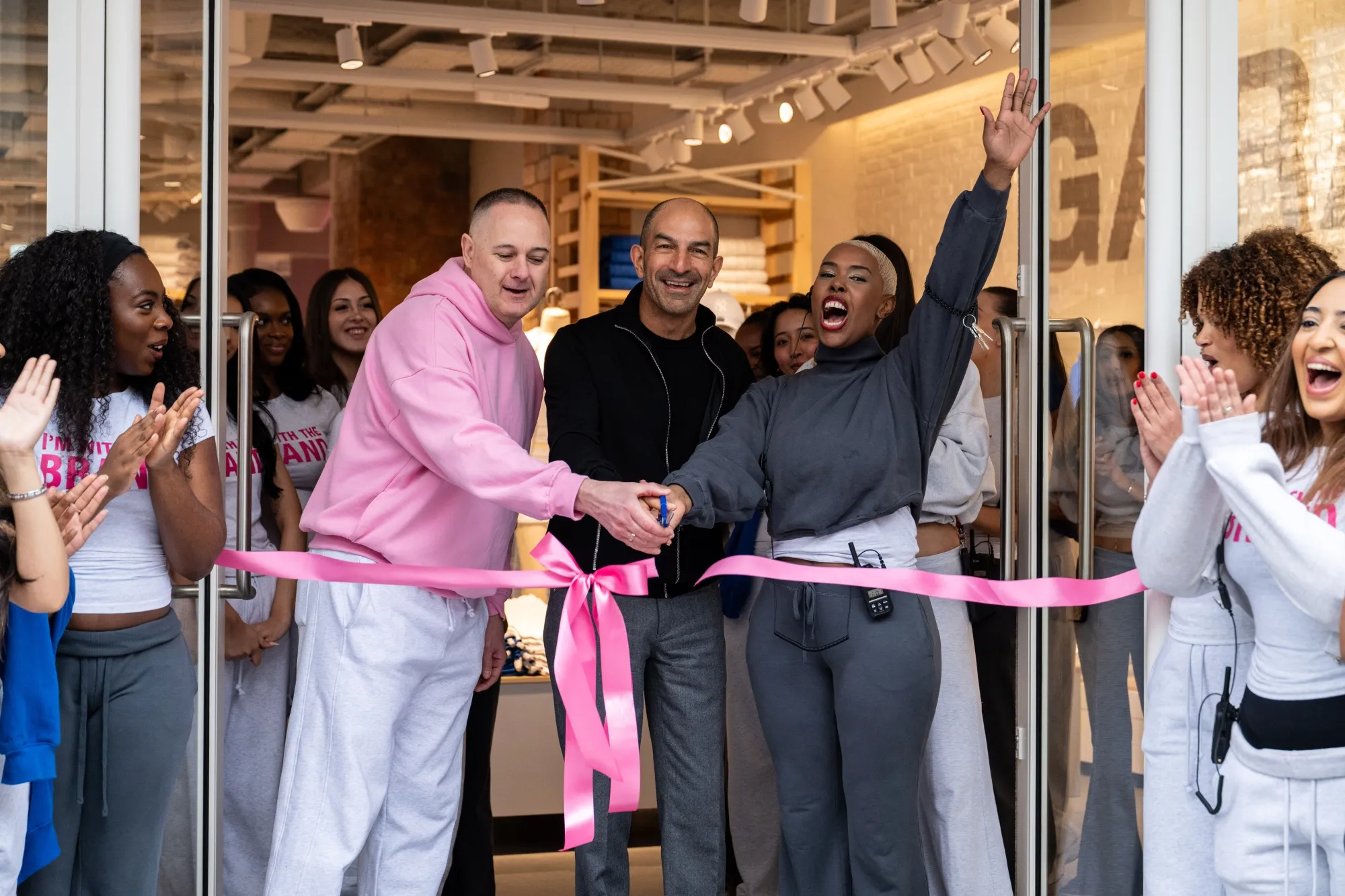 Andrew Lutfy, chief executive officer of Groupe Dynamite Inc., center, cuts the ribbon on the newly opened Garage Clothing store on Oxford Street in London on March 27.