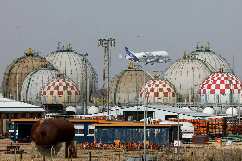 An Airbus Beluga transport airliner flies over storage tanks at a Liquefied Petroleum Gas factory in Pinto, near Madrid, on March 5.