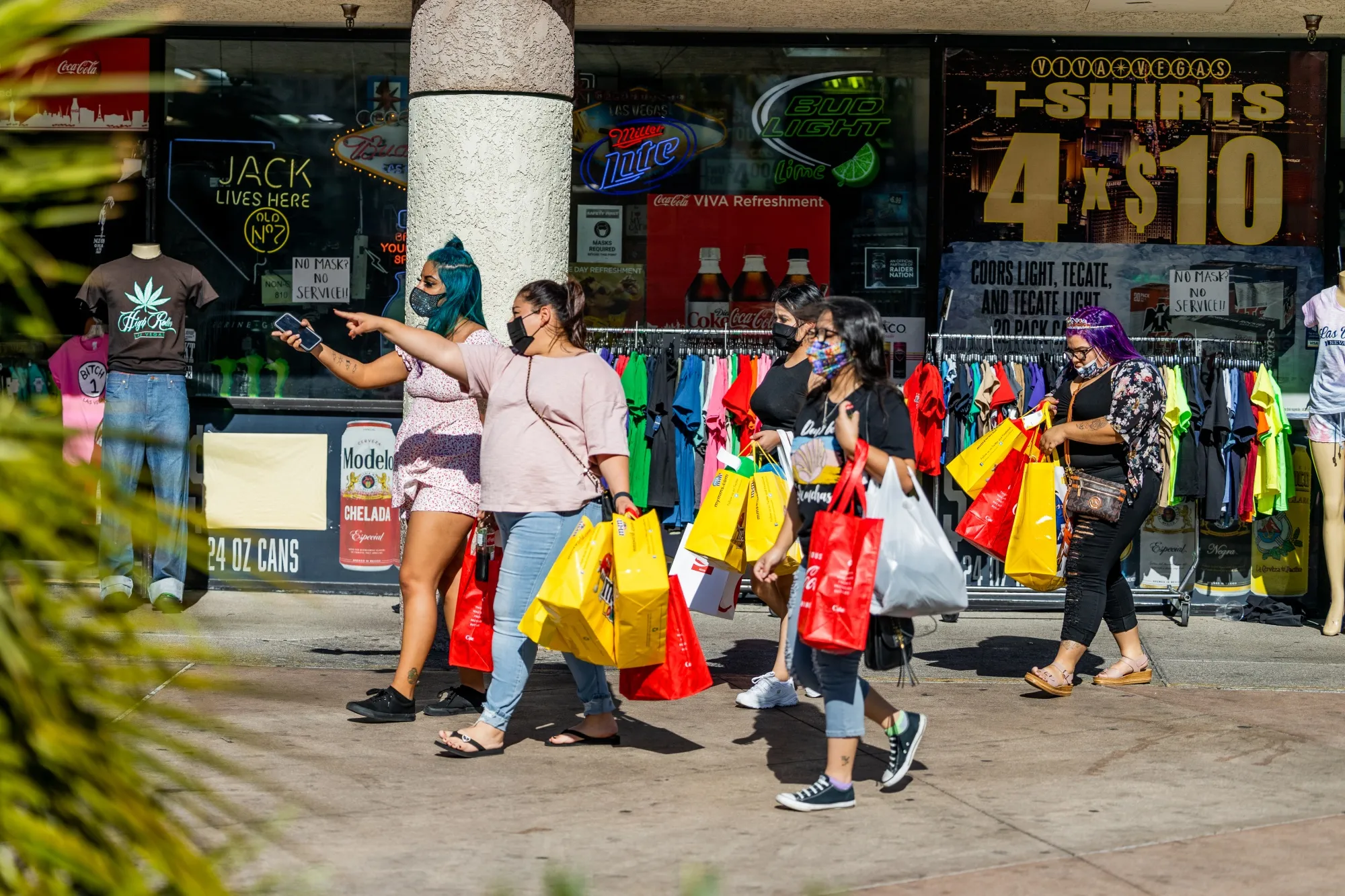People carry shopping bags while walking along the Las Vegas Strip.