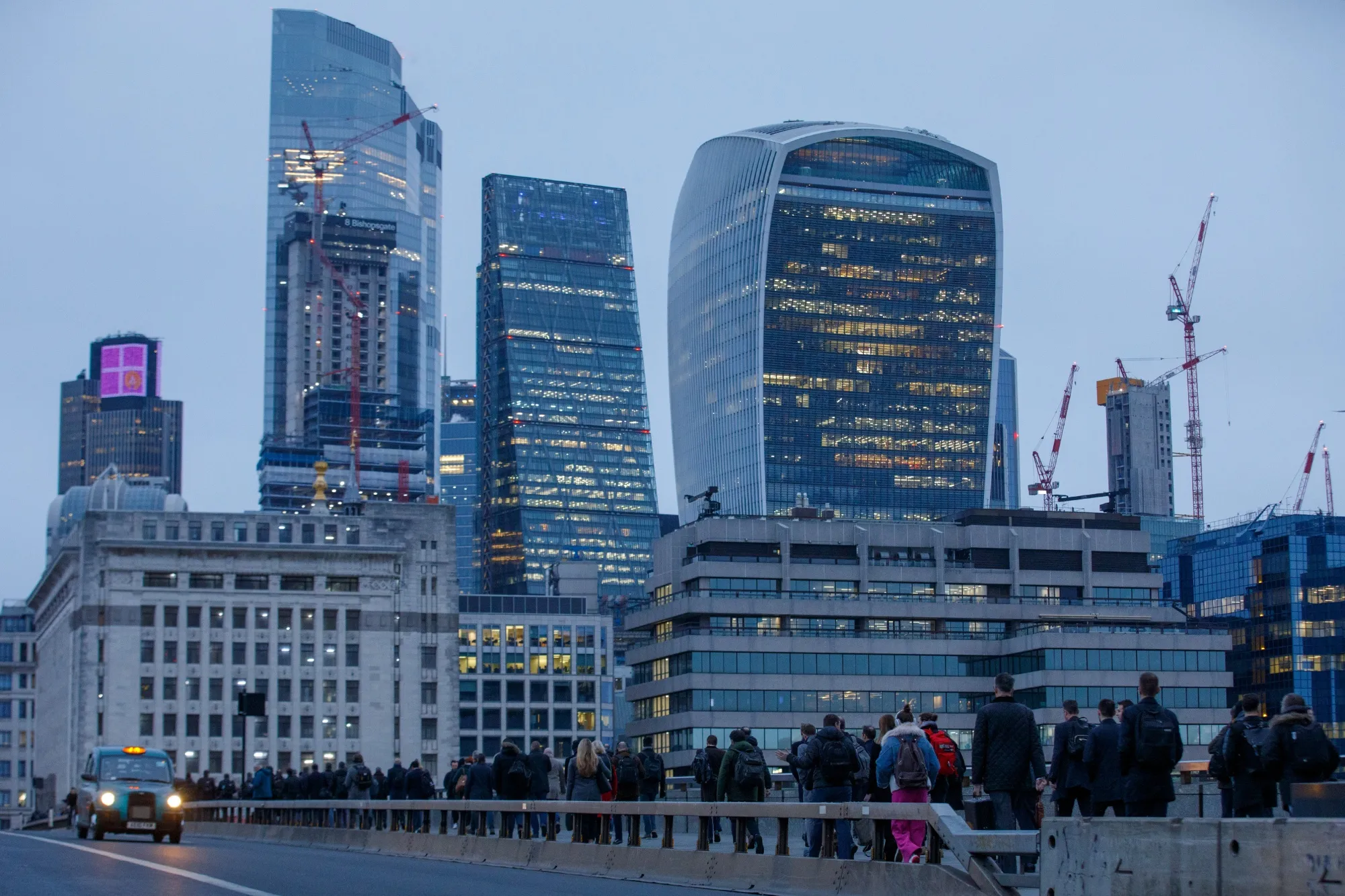 Morning commuters cross London Bridge towards the City of London.