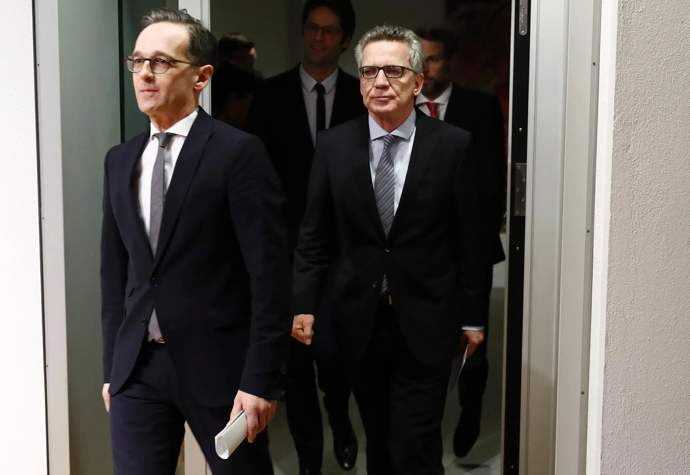 German Justice Minister Heiko Maas, left, and German Interior Minister Thomas de Maiziere leave after a press conference on security reforms after the Berlin truck attack in Berlin, on Jan. 10.
