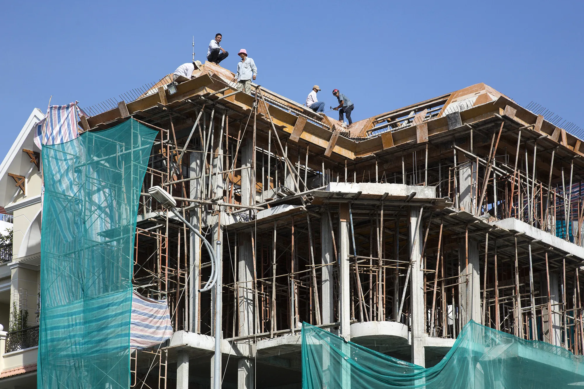 Workers labor at a residential construction site in Ho Chi Minh City, Vietnam, on Thursday, Jan. 11, 2018. A global trade recovery and Vietnam’s young and low-cost workforce have been magnets for international investors like Nestle SA, which have opened factories in the country this year. That’s helping underpin its economy, which expanded 6.8 percent in 2017, among the fastest in the world.