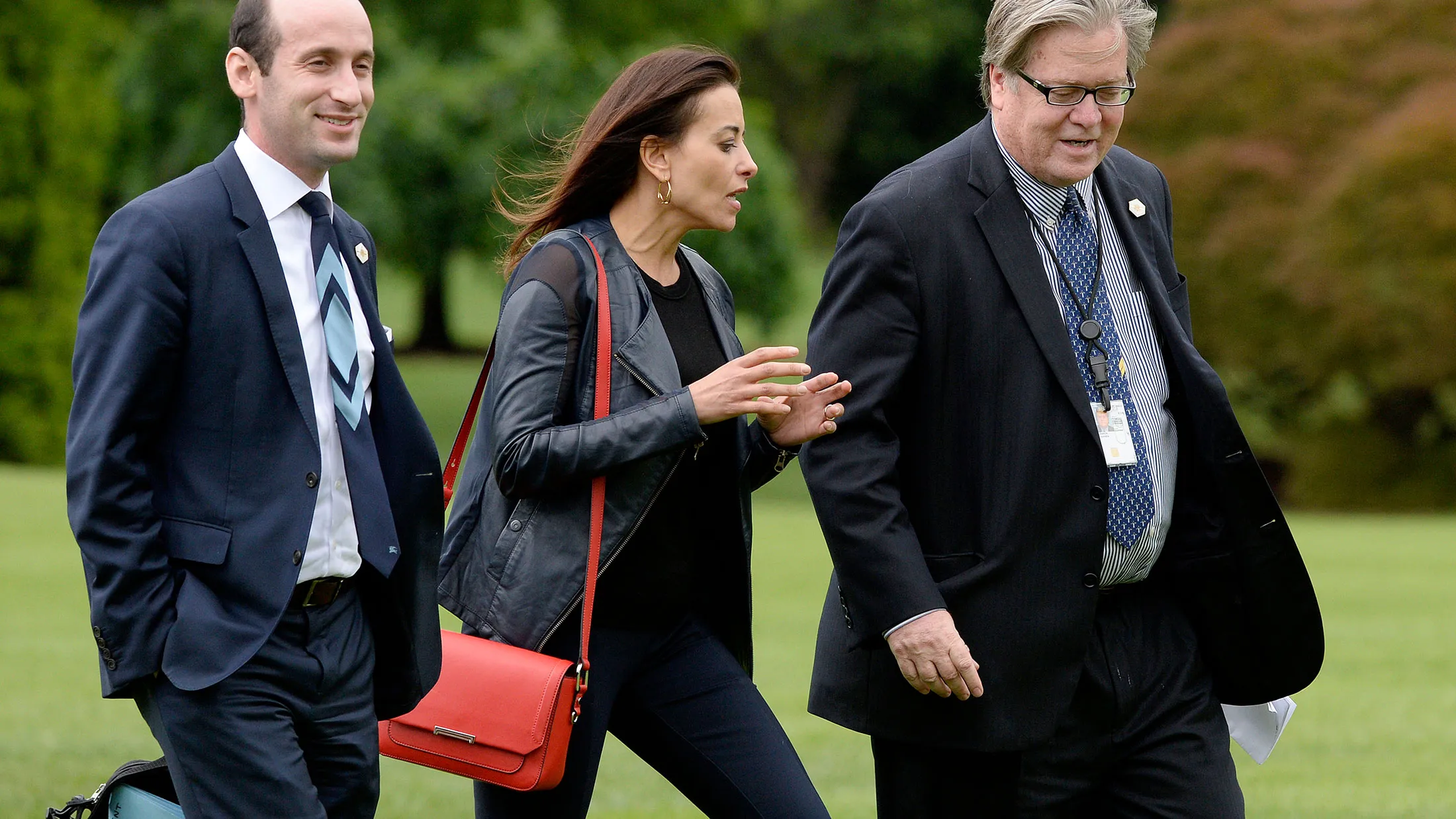 White House aides Stephen Miller, Dina Powell and Steve Bannon exit Marine One on the South Lawn on May 13, 2017.