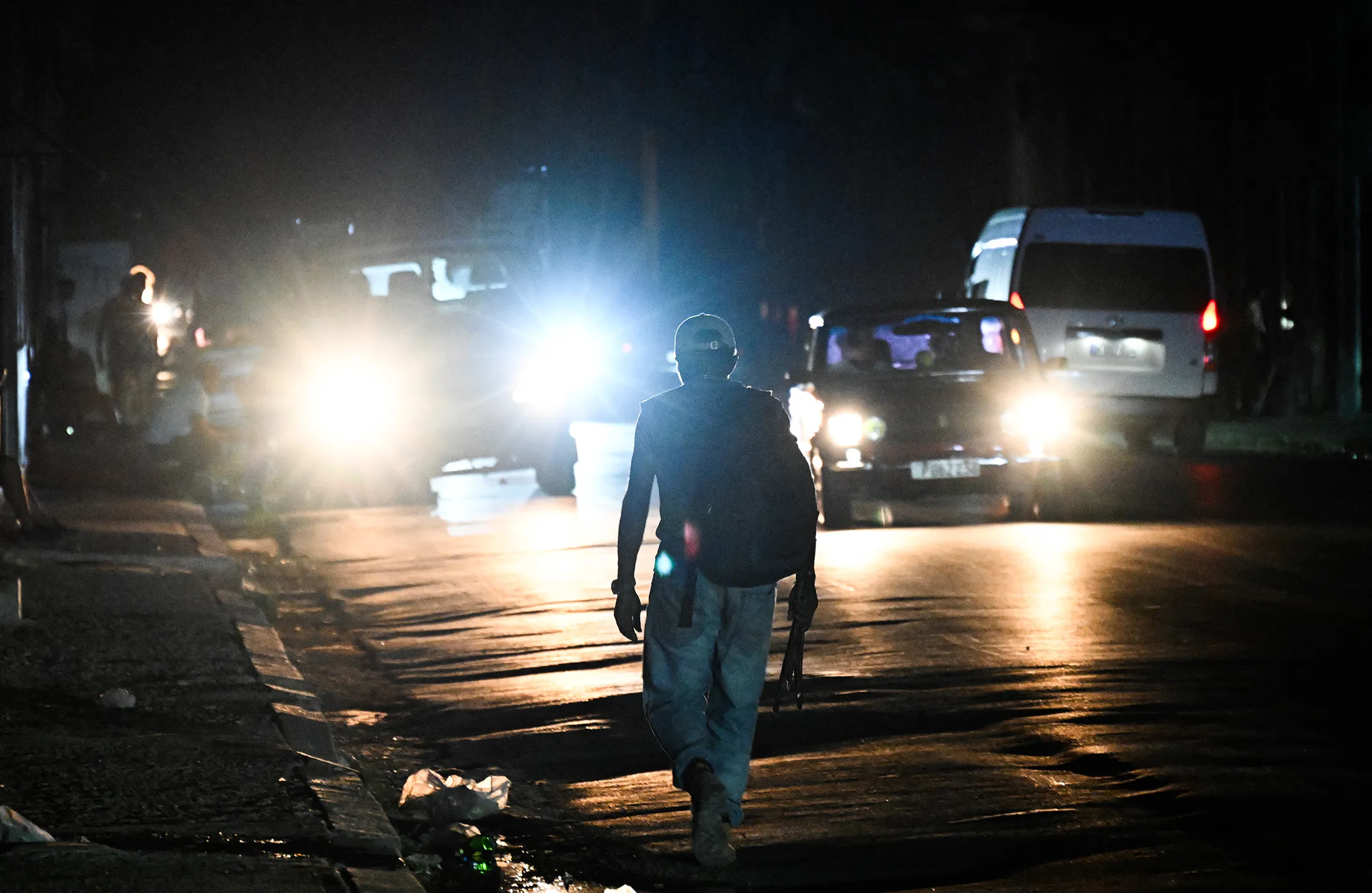A residents walks in the street during a power outage in Havana on June 26.