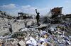 A Syrian soldier films the damage of the Syrian Scientific Research Center.