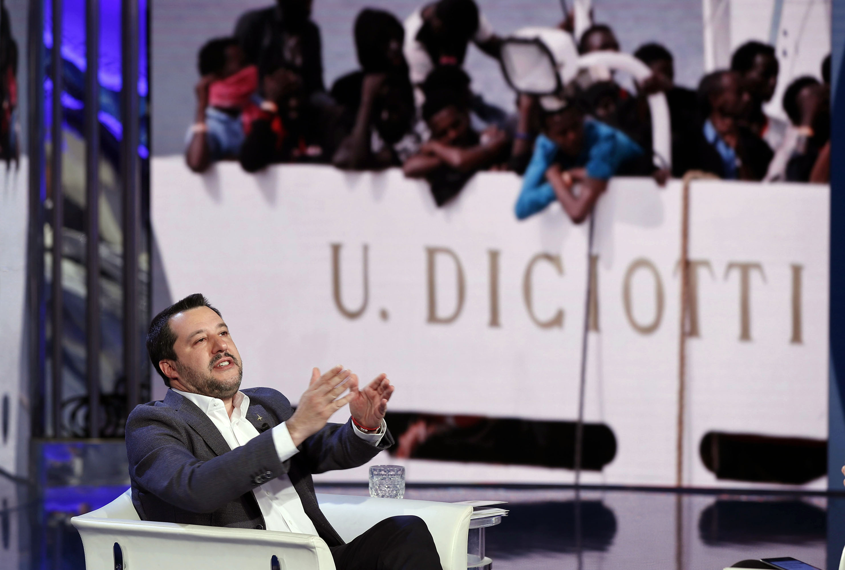 Matteo Salvini with a background image of&nbsp;migrants on Diciotti ship. Rome.