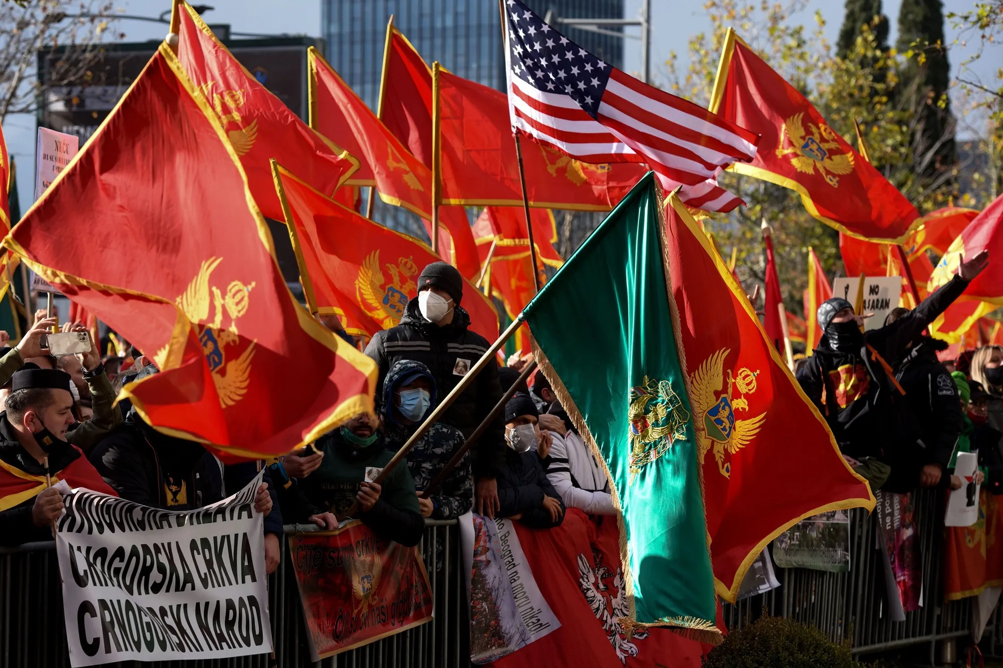 Protesters wave Montenegro flags during a demonstration against the new government, in Podgorica, on Dec.&nbsp;28.