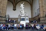 Visitors take a break in Florence's Piazza Della Signoria
