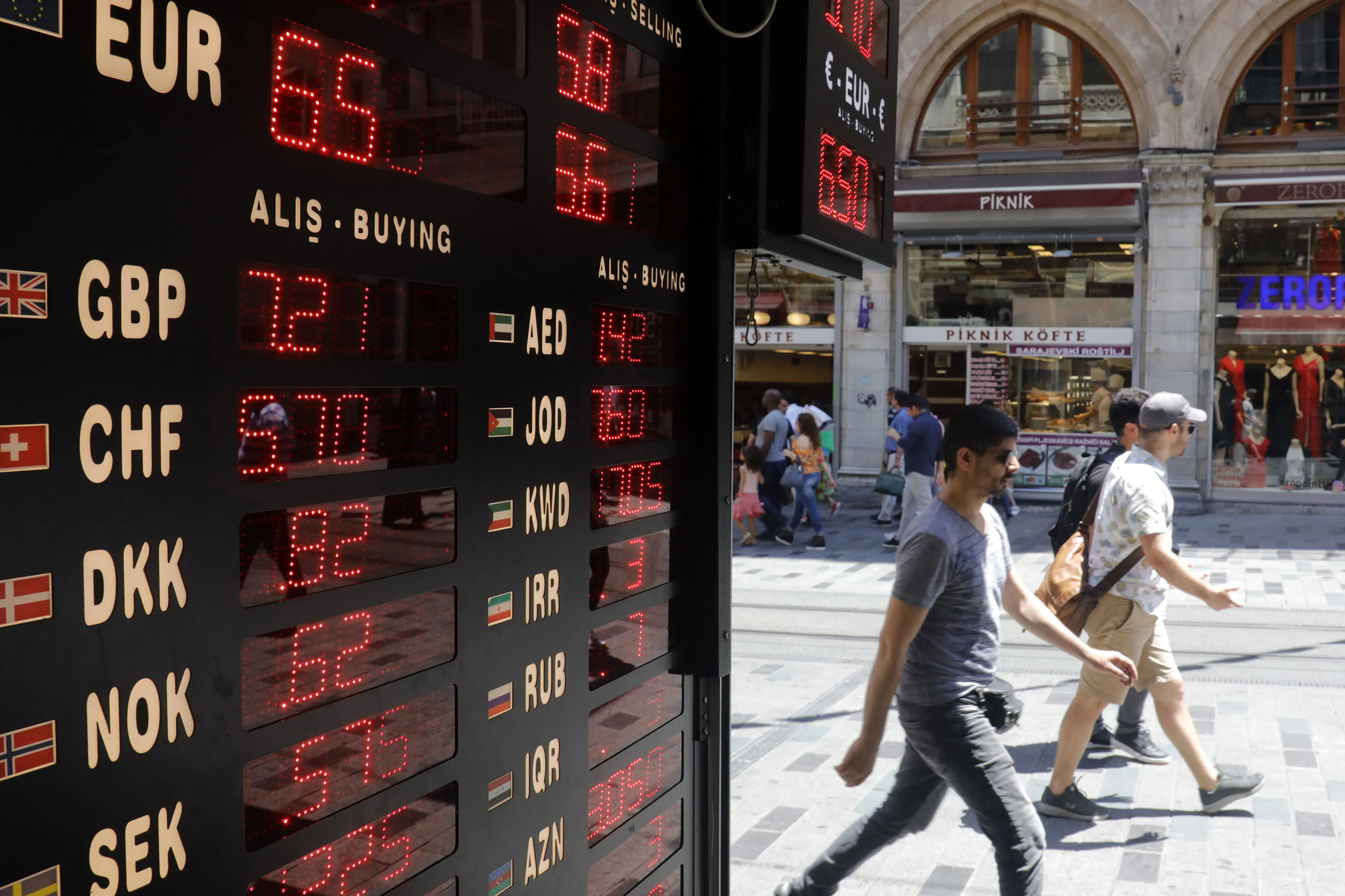 Foreign currency exchange rates are displayed on a digital board outside a bureau de change in Istanbul.