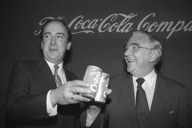 Robert C. Goizueta, chairman and CEO of Coca-Cola, left, toasts cans of New Coke with Coca-Cola President Donald R. Keough, in 1985
